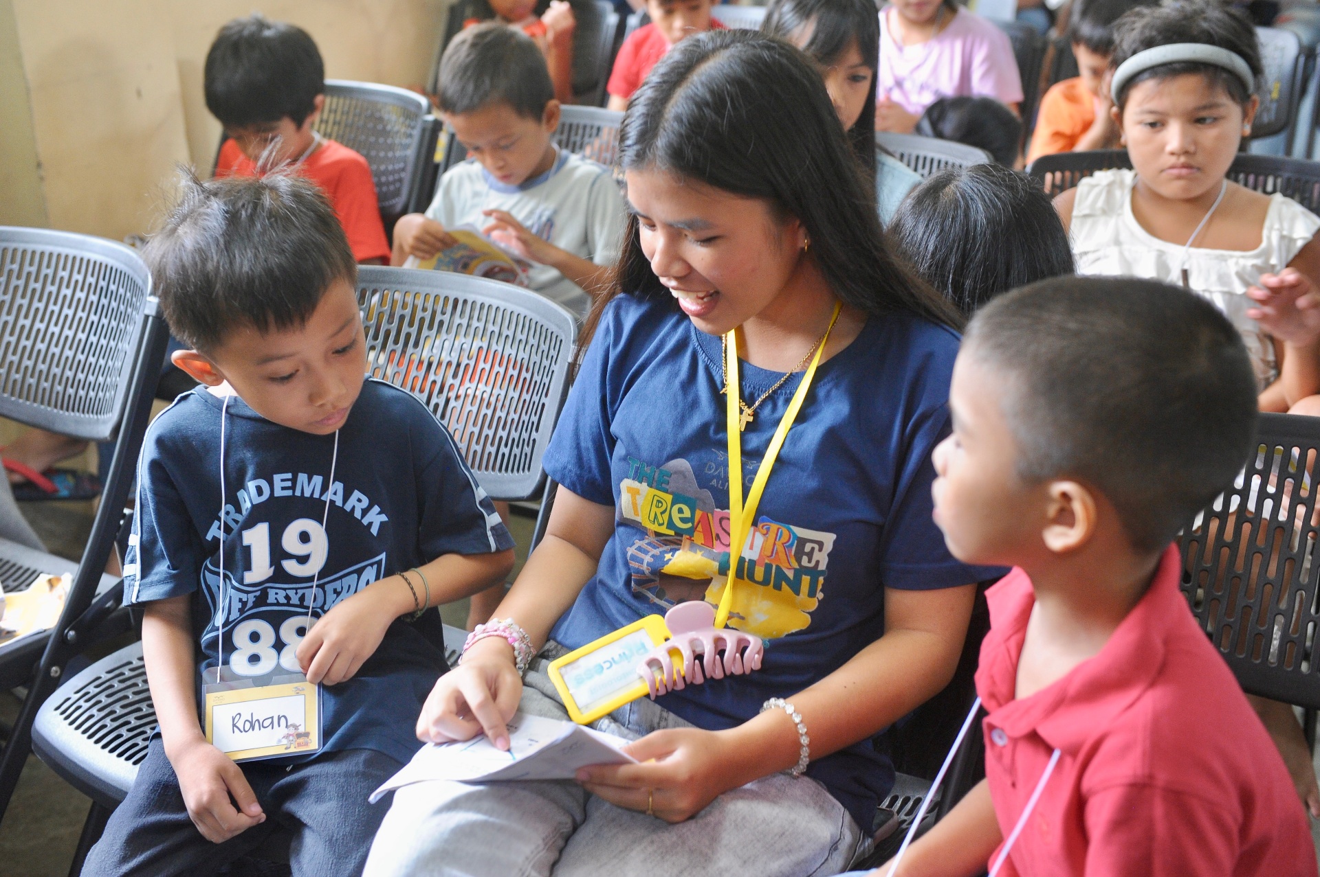 A leader reading the Bible one-on-one with a child during summer club